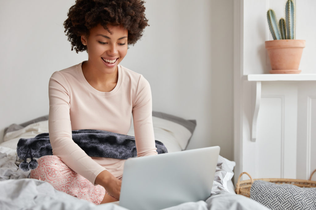 Woman with extra long water bottle and laptop