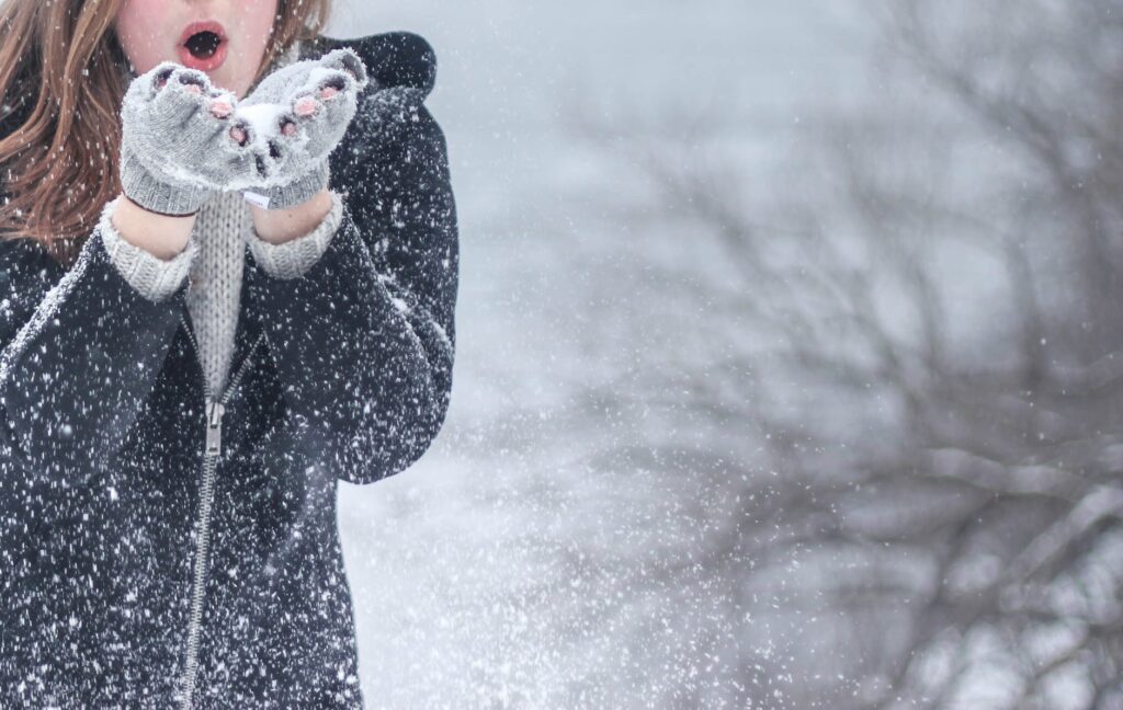 woman blowing snow